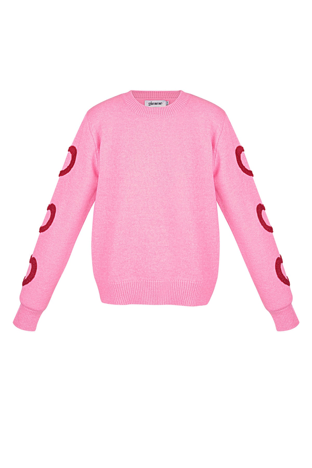 Roze gebreide trui met rode hart details op de mouwen
