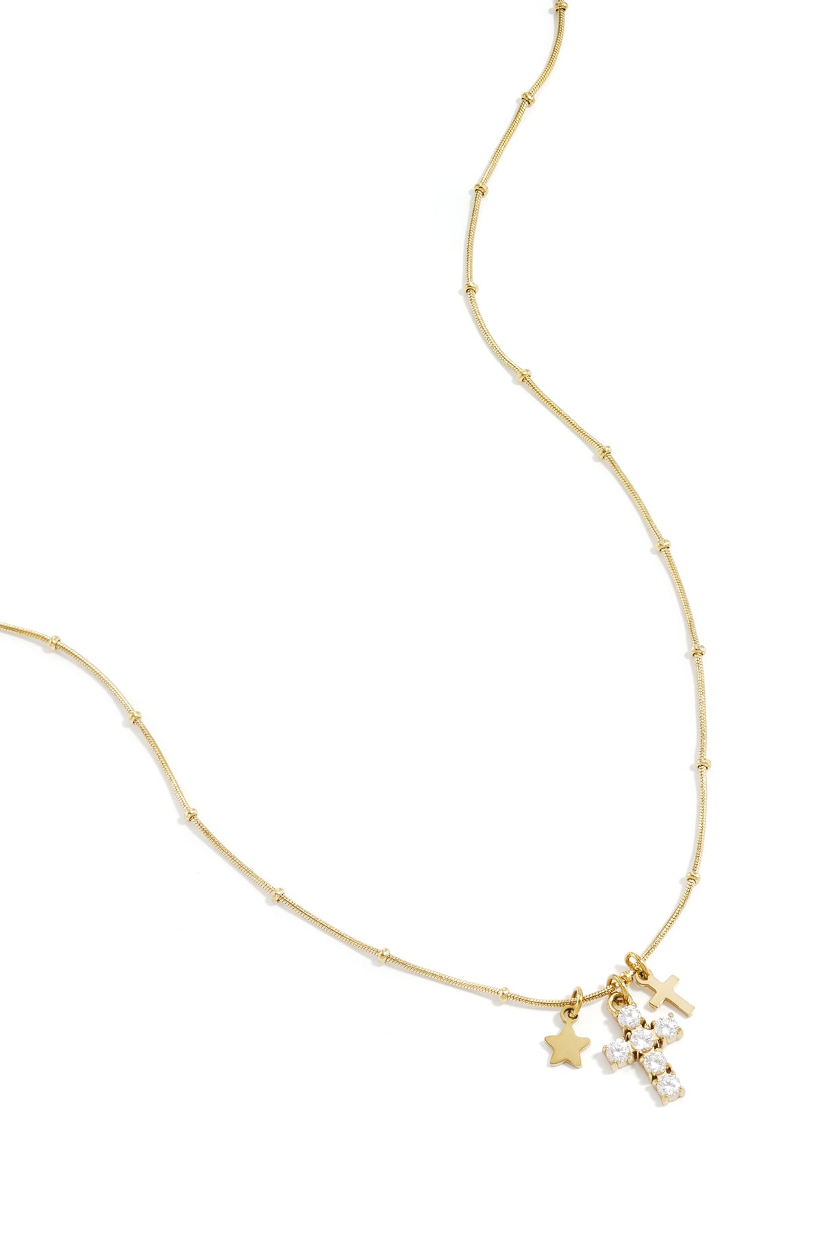 Goudkleurige schakelketting met kruis en ster charms bezet met kristallen