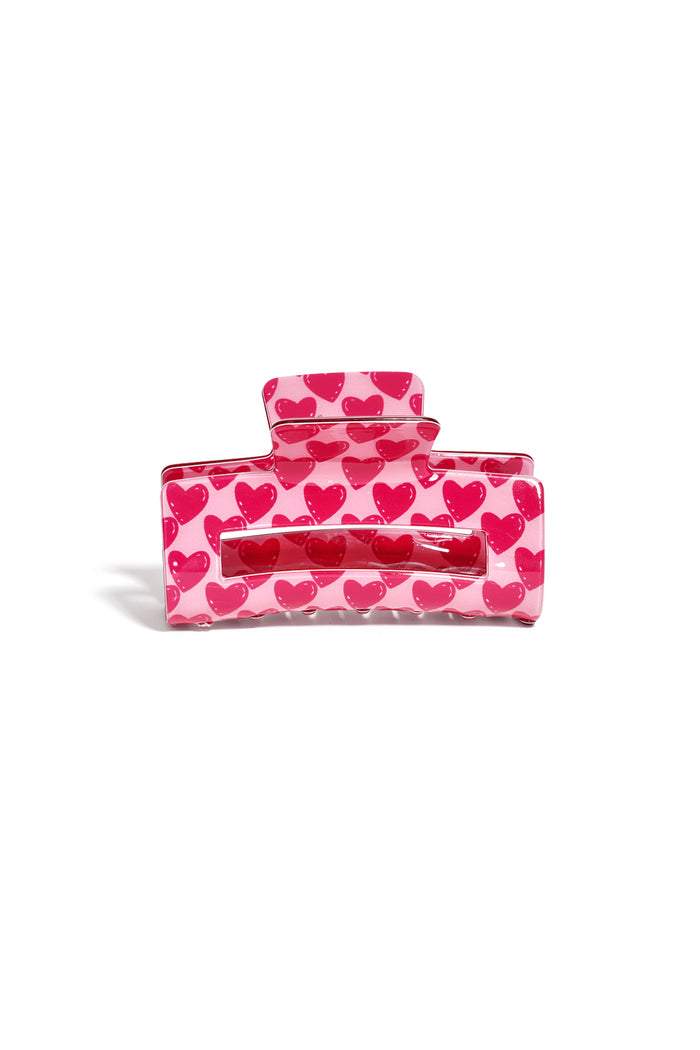 Roze haarspeld van acryl met wit en roze hartjespatroon